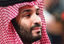 A man wearing traditional Saudi attire with a red and white headdress