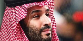 A man wearing traditional Saudi attire with a red and white headdress