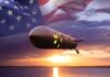 A nuclear missile with an American flag backdrop during sunset