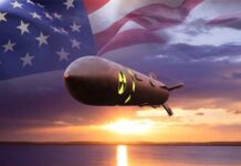 A nuclear missile with an American flag backdrop during sunset