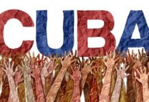 Colorful representation of the word 'CUBA' with raised hands in the background