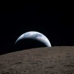 View of Earth rising above the lunar surface