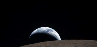 View of Earth rising above the lunar surface