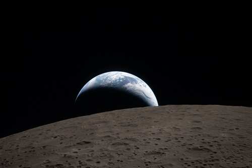 View of Earth rising above the lunar surface