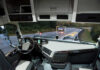 Interior view of a truck with a focus on the dashboard and road ahead