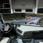 Interior view of a truck with a focus on the dashboard and road ahead