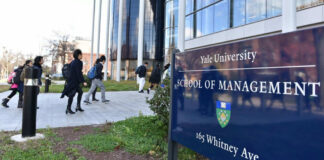 People walking outside Yale School of Management building
