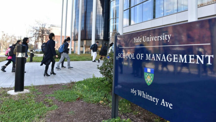 People walking outside Yale School of Management building