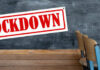 Teen’s Ghost Gun Factory Busted! A sign reading 'LOCKDOWN' hanging in a classroom with empty chairs