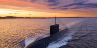 A submarine navigating through the ocean during sunset