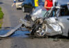 Severely damaged car after a collision on the road
