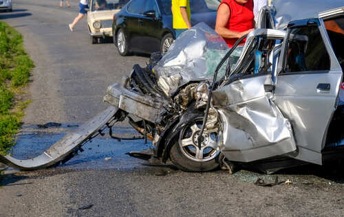 Severely damaged car after a collision on the road
