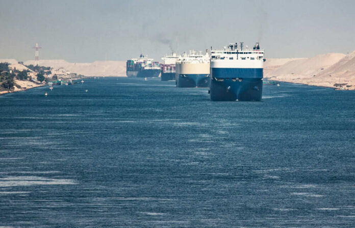 1282946971 Multiple cargo ships in a narrow canal passage